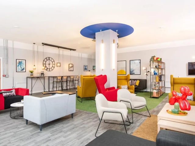 Lounge area with sofas chairs and bar stools Living room at Rockingham House in Sheffield Student Accommodation