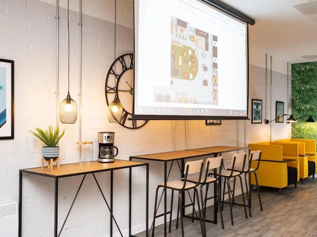 Projection screen coffee maker clock bar seating lounge at Rockingham House in Sheffield Student Accommodation