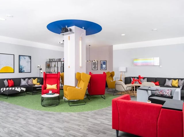 Colorful lounge with sofas chairs and artwork Living area at Rockingham House in Sheffield Student Accommodation