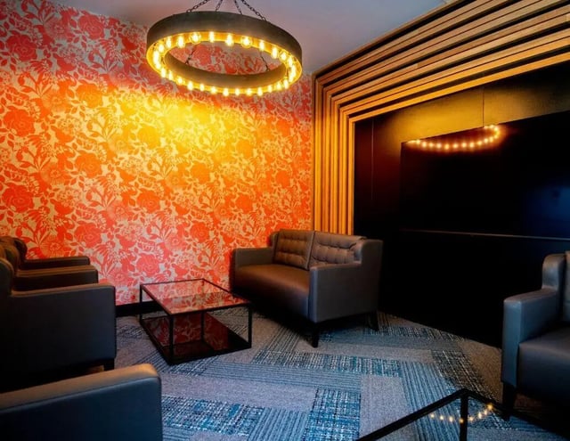 Sofas glass table floral wallpaper living room at IconInc Newcastle City in Newcastle Upon Tyne Student Accommodation