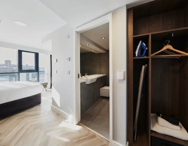 Bed ironing board and hangers bedroom bathroom at IconInc Newcastle City in Newcastle Upon Tyne Student Accommodation
