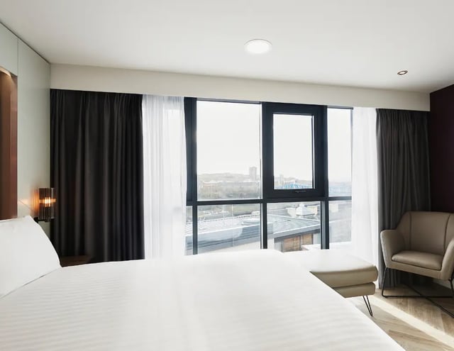 Bed ottoman chair large window bedroom at IconInc Newcastle City in Newcastle Upon Tyne Student Accommodation