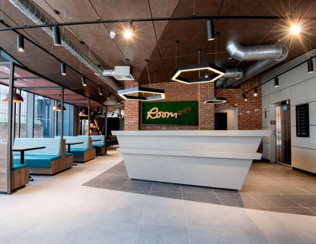 Reception desk with booths and elevator exterior lobby at IconInc Newcastle City in Newcastle Upon Tyne Student Accommodation