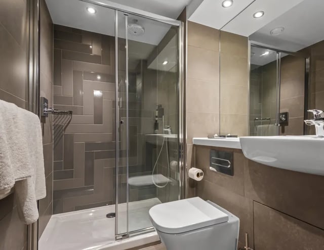 Shower toilet sink tiled bathroom interior at IconInc Newcastle City in Newcastle Upon Tyne Student Accommodation