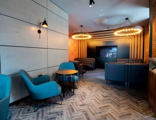 Blue chairs wooden table seating area living room at IconInc Newcastle City in Newcastle Upon Tyne Student Accommodation