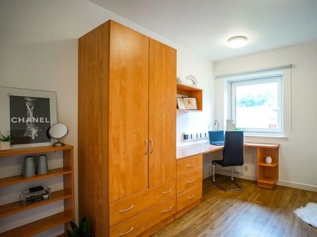 Wardrobe desk chair and shelves study area at Exeter One in Exeter Student Accommodation