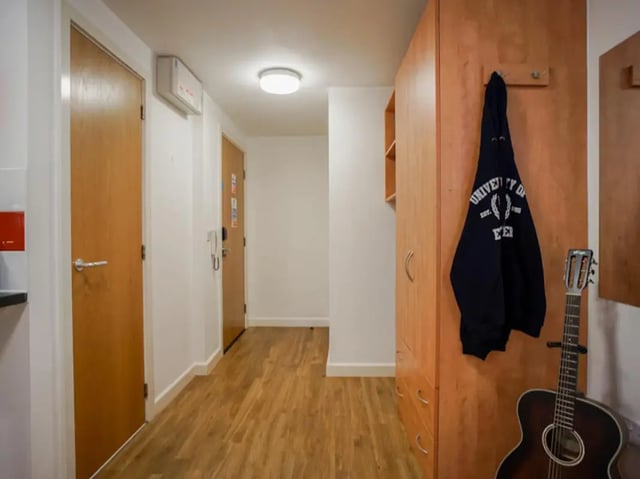 Wooden doors, wardrobe, guitar, and hoodie hall at Exeter One in Exeter Student Accommodation