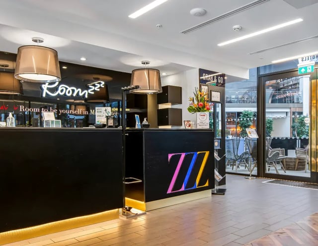 Reception desk with ZZz logo and hotel exterior at Manchester Victoria in Manchester Student Accommodation