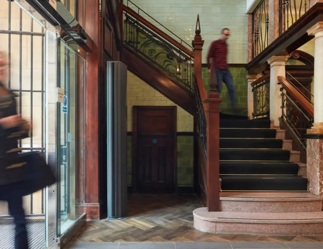 Wooden staircase glass door and person hallway at Manchester Victoria in Manchester Student Accommodation