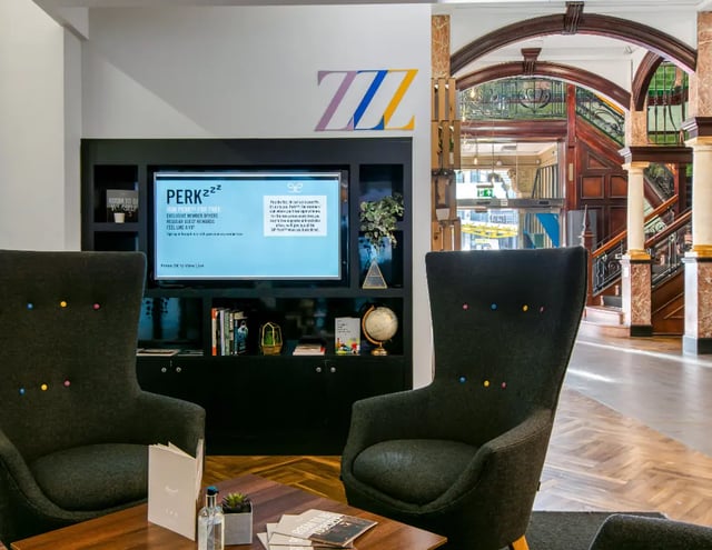 Two armchairs TV and staircase living area at Manchester Victoria in Manchester Student Accommodation