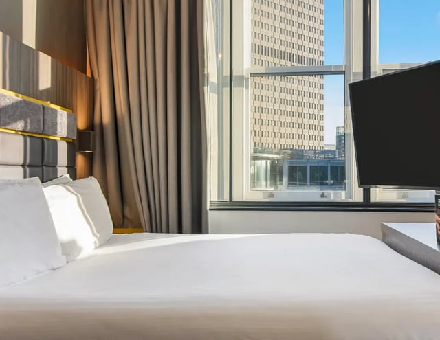 Bed pillows curtain television window exterior bedroom at Manchester Victoria in Manchester Student Accommodation