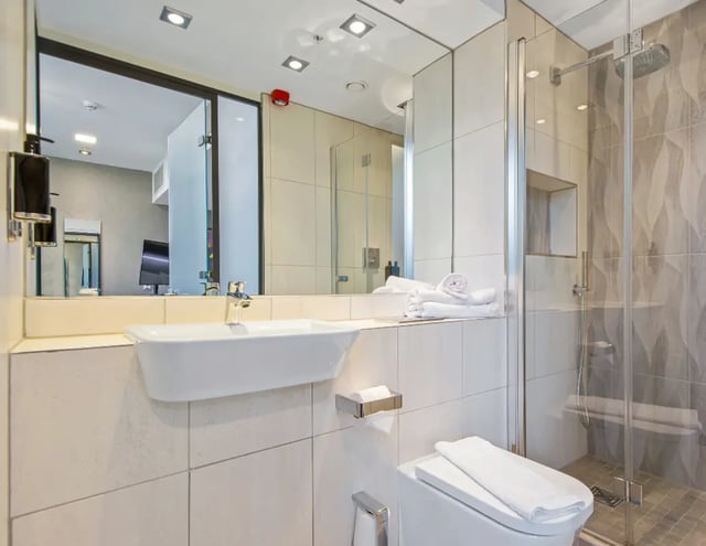 Sink toilet shower towels and mirror bathroom at Manchester Victoria in Manchester Student Accommodation