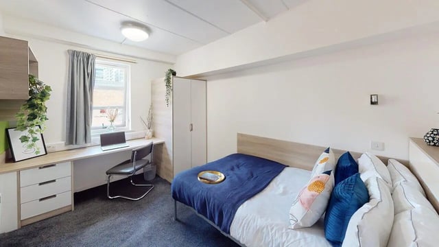 Desk bed closet and pillows bedroom at Manchester Student Village in Manchester Student Accommodation