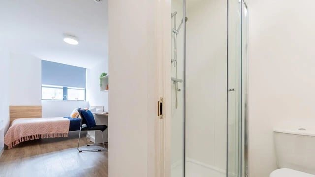 Bed desk chair and shower cubicle bathroom at Manchester Student Village in Manchester Student Accommodation