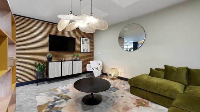 Modern living room with velvet sofa and circular mirror living room at Heantun Point in Wolverhampton Student Accommodation