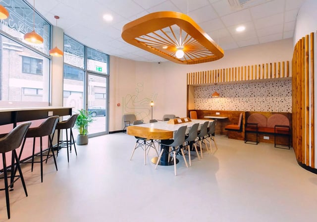 Large table chairs and bar area communal room at iQ Exchange in Nottingham Student Accommodation