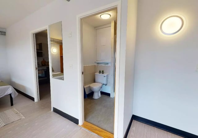 Toilet and shower visible inside small room bathroom at iQ Exchange in Nottingham Student Accommodation