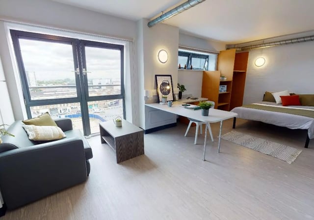 Sofa table desk bed shelving room exterior at iQ Exchange in Nottingham Student Accommodation