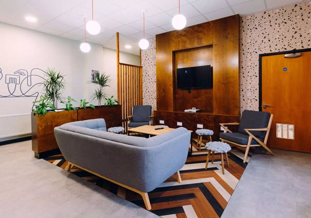 Sofa chairs table plants TV living room at iQ Exchange in Nottingham Student Accommodation