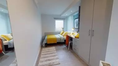 Bed desk wardrobe and rug bedroom at iQ Broderick House in Birmingham Student Accommodation