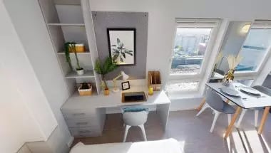 Desk with chair artwork shelving and dining table bedroom at iQ Broderick House in Birmingham Student Accommodation