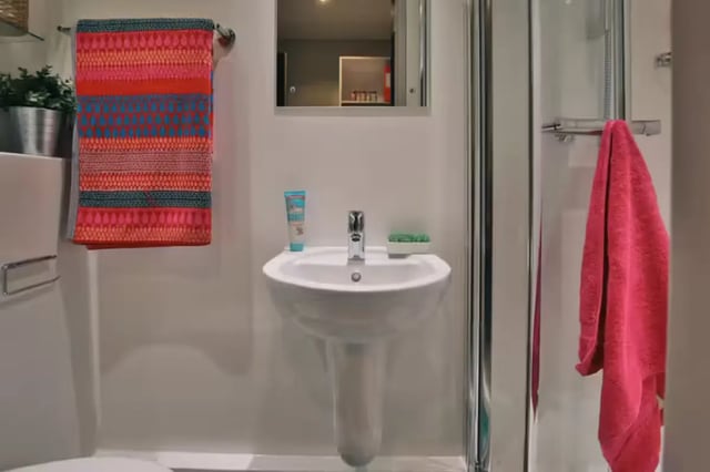 Sink with colorful towel and pink towel Bathroom at Clifton Place in Exeter Student Accommodation