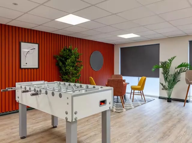 Foosball table chairs and plants common area at Trinity Student Village in Preston Student Accommodation
