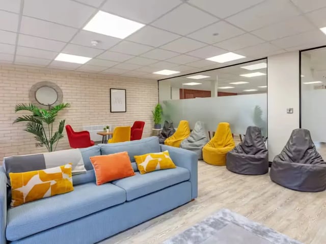 Blue sofa beanbags chairs table and plant living room at Trinity Student Village in Preston Student Accommodation