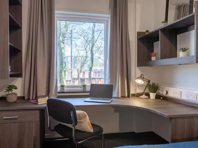 Desk with laptop chair and window study area at Trinity Student Village in Preston Student Accommodation