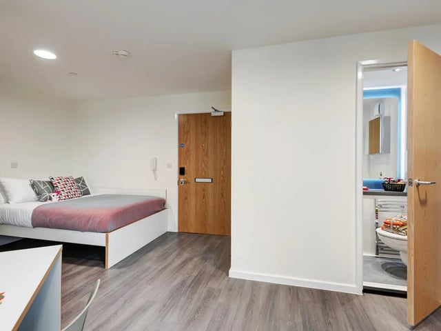 Bed desk and bathroom visible studio apartment at New Bridewell in Bristol Student Accommodation