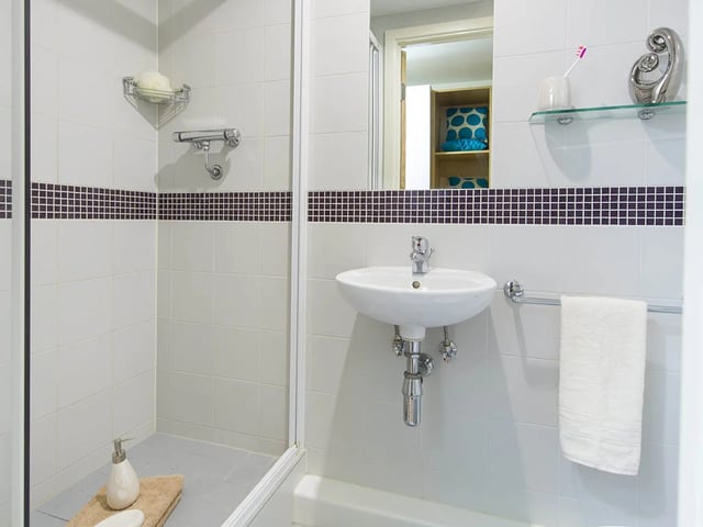 Shower sink towel holder and toiletries bathroom at Quebec House in Kingston Upon Thames Student Accommodation