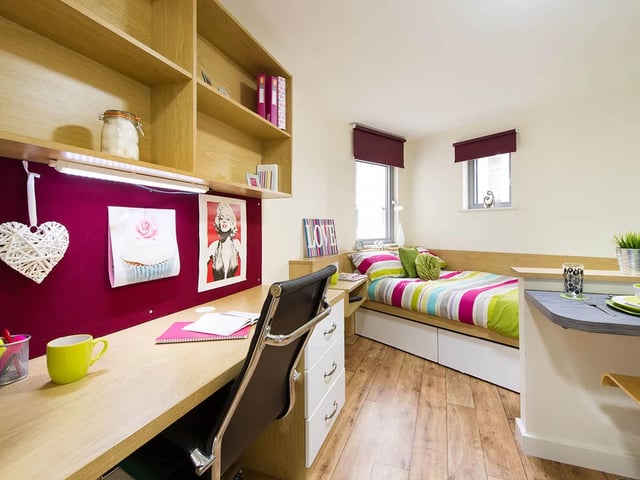 Bed desk and shelving with colorful bedding bedroom at Quebec House in Kingston Upon Thames Student Accommodation