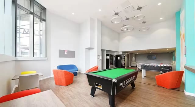 Pool table foosball tables colorful chairs living room at The Mill House in Edinburgh Student Accommodation