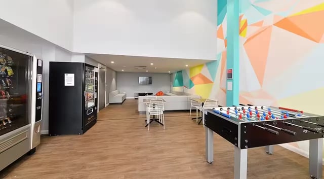 Vending machines foosball table sofa living room at The Mill House in Edinburgh Student Accommodation