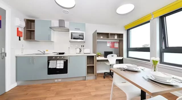 Kitchen with desk and dining table at The Mill House in Edinburgh Student Accommodation