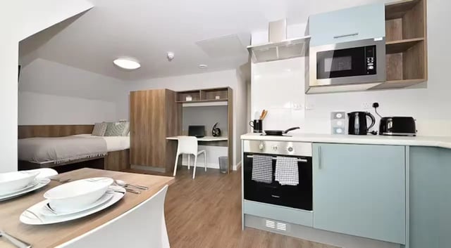 Bed study area kitchen living room studio apartment at The Mill House in Edinburgh Student Accommodation
