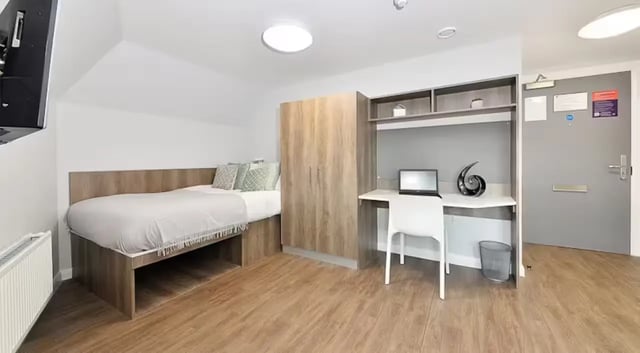 Bed wardrobe desk with laptop bedroom at The Mill House in Edinburgh Student Accommodation