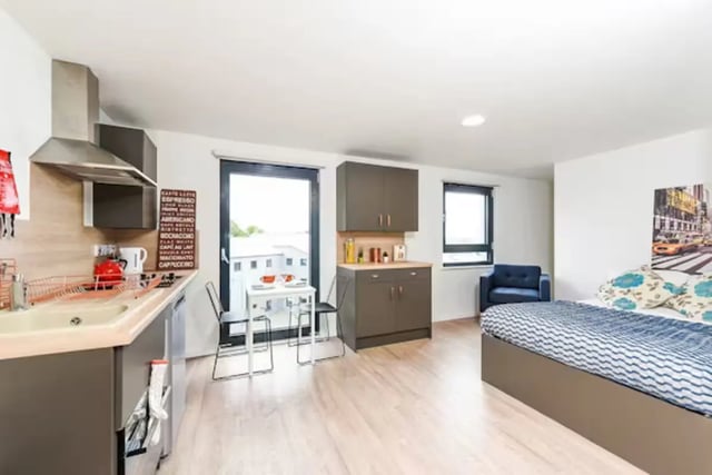 Kitchenette bed blue chair and small table studio at The Towpath in Chester Student Accommodation