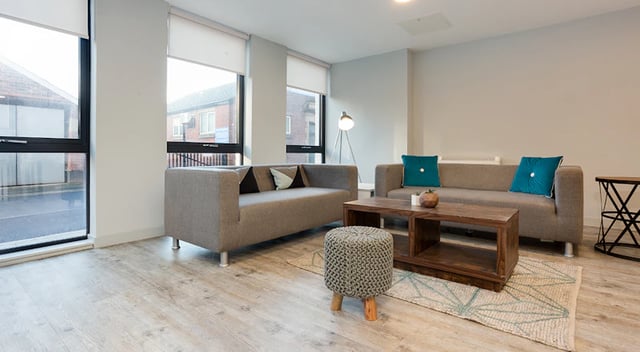 Two gray sofas coffee table ottoman living room at The Tramshed in Preston Student Accommodation