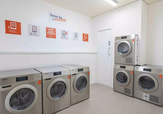 Multiple Miele washing machines and dryers Laundry room at iQ Studios 51 in Birmingham Student Accommodation