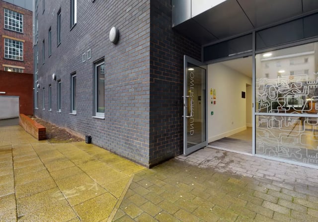Building entrance with glass doors and windows exterior at iQ Studios 51 in Birmingham Student Accommodation