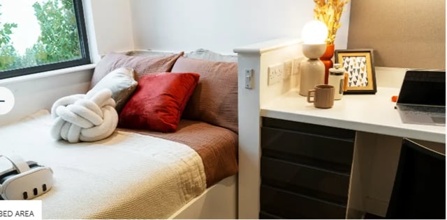 Bed with pillows and desk with laptop bedroom at Palamon Court in Canterbury Student Accommodation