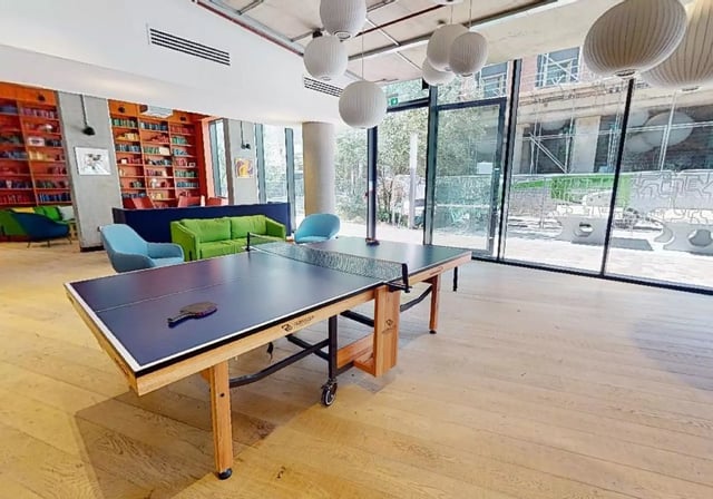 Ping pong table with sofas and bookshelves communal area at iQ Brighton in Brighton Student Accommodation