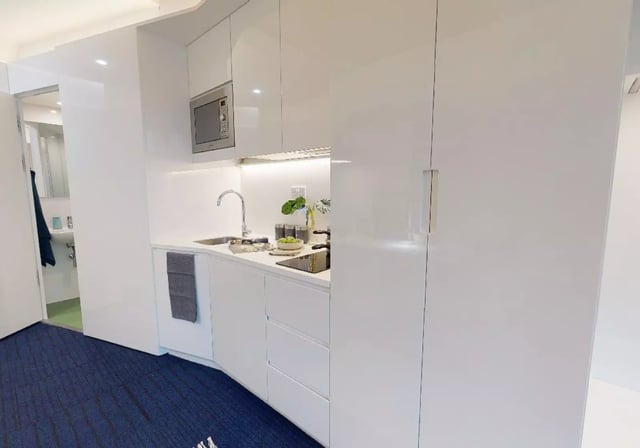 White kitchen with microwave sink and stovetop kitchen at iQ Brighton in Brighton Student Accommodation