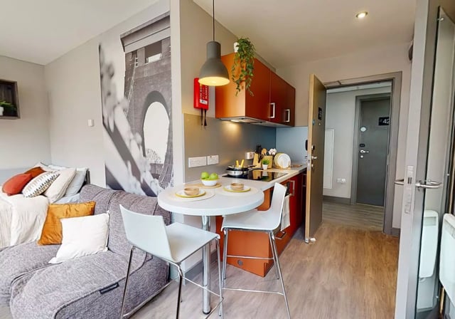 Sofa table chairs kitchen cabinets and fire blanket studio at Waterlane House in Bristol Student Accommodation