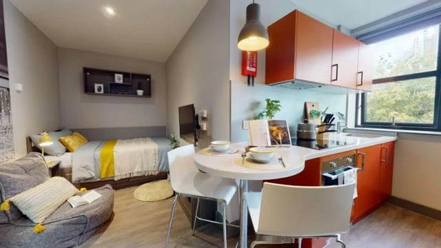 Bed desk seating and kitchen student studio apartment at Waterlane House in Bristol Student Accommodation
