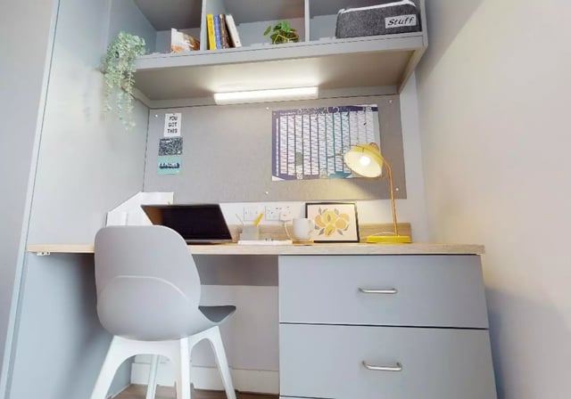 Desk with laptop chair drawers lamp artwork study area at iQ Weaver Place in Coventry Student Accommodation