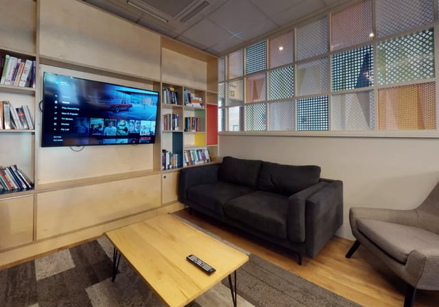 Sofa coffee table television and bookshelves living room at Opal Court Leicester in Leicester Student Accommodation