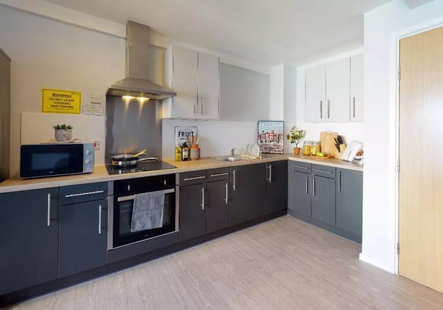 Microwave oven stovetop sink cabinets and counter kitchen at Opal Court Leicester in Leicester Student Accommodation