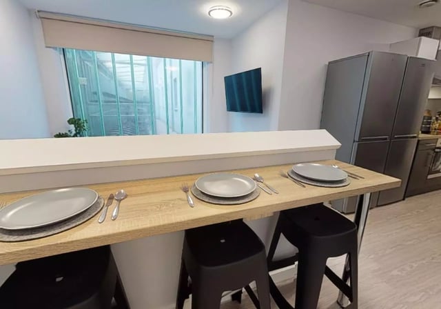 Plates cutlery and bar stools kitchen area at iQ Will Wyatt Court in London Student Accommodation